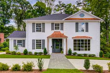 Updated two story colonial, white brick facade, copper awnings