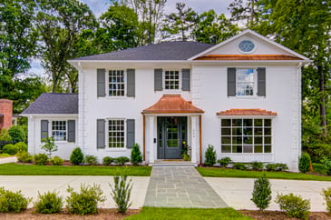 Updated two story colonial, white brick facade, copper awnings