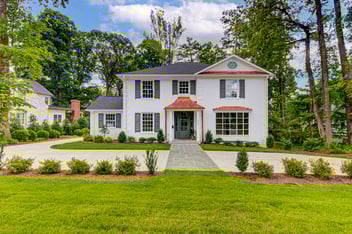 Updated two story colonial, white brick facade, copper awnings