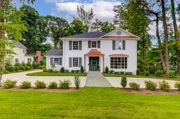 Updated two story colonial, white brick facade, copper awnings