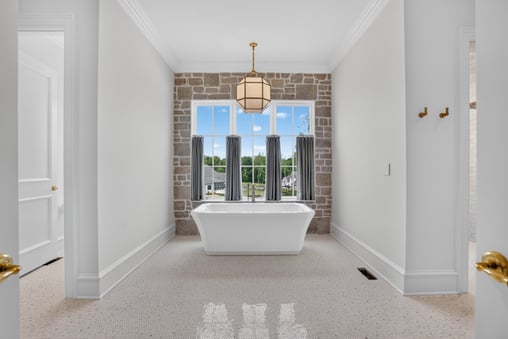Standing tub, custom primary bath suite by Wolfe Homes