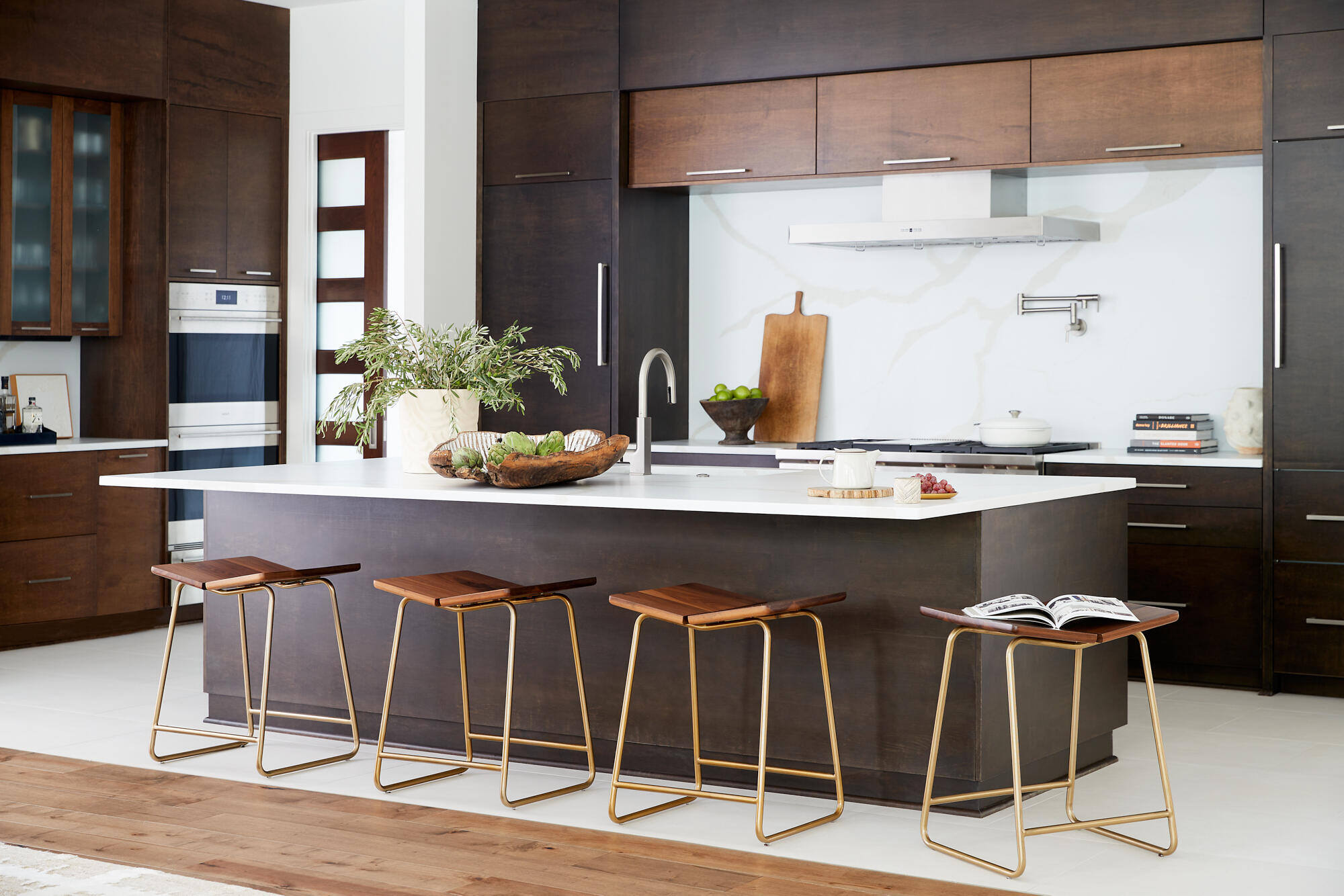 Sleek kitchen design with dark wood cabinets and modern bar seating by Allen & James in Gaston County
