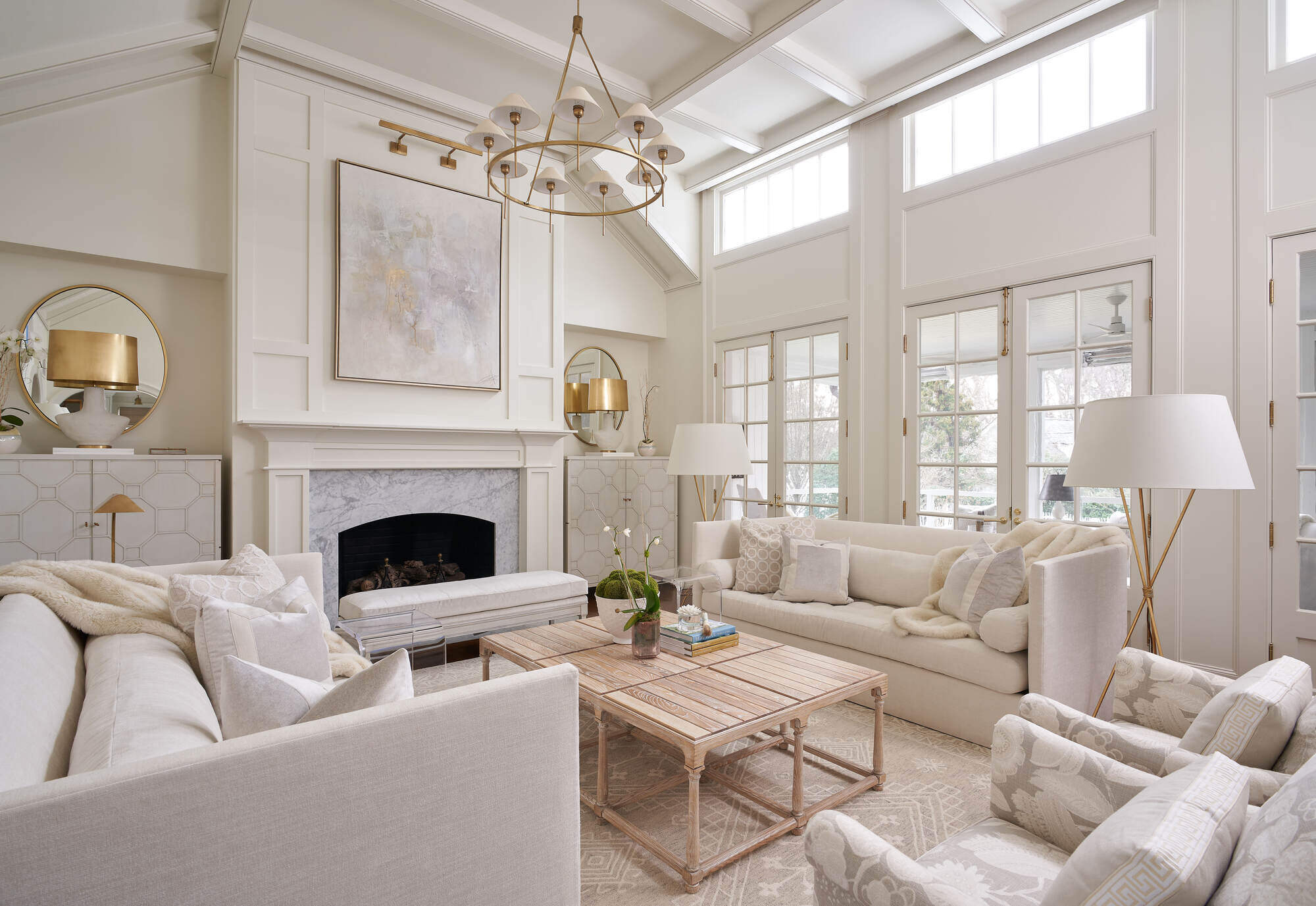 Spacious living room with large windows and neutral decor in a custom Greensboro remodel by Wolfe Homes