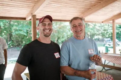 Alex and Jim Wolfe smiling at a Wolfe Homes company event in Greensboro, NC