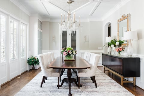 Elegant dining room in a custom home by Wolfe Homes in Greensboro, NC, with a long table and chandelier