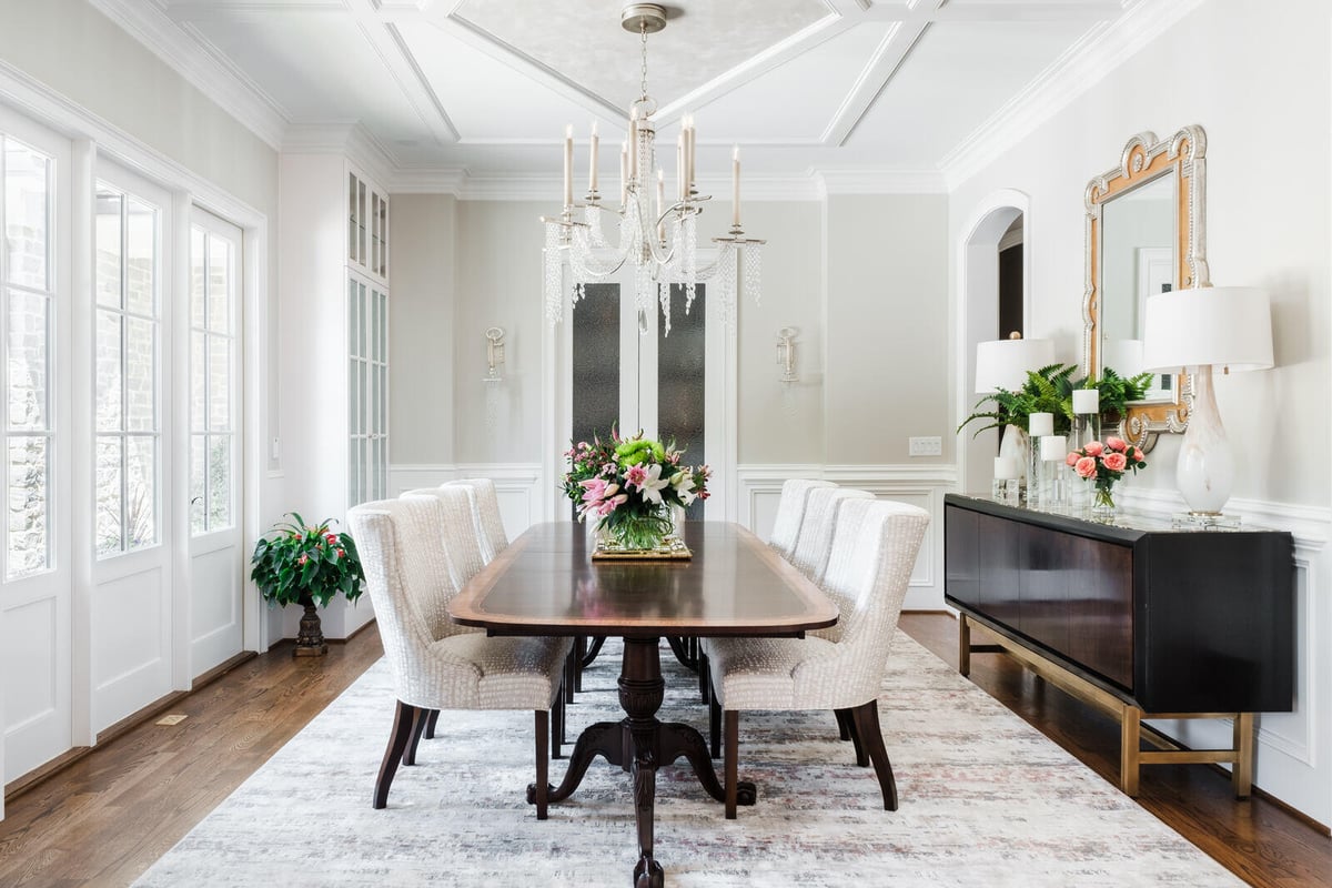Elegant dining room in a custom home by Wolfe Homes in Greensboro, NC, featuring a chandelier and floral centerpiece