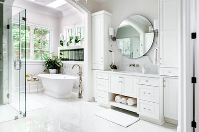 Luxurious white bathroom with round mirror in a custom Wolfe Homes build, Greensboro, NC