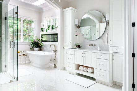Luxurious white bathroom with round mirror in a custom Wolfe Homes build, Greensboro, NC