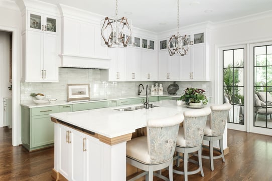 Modern kitchen with white and green cabinetry in a custom home by Wolfe Homes, Greensboro, NC