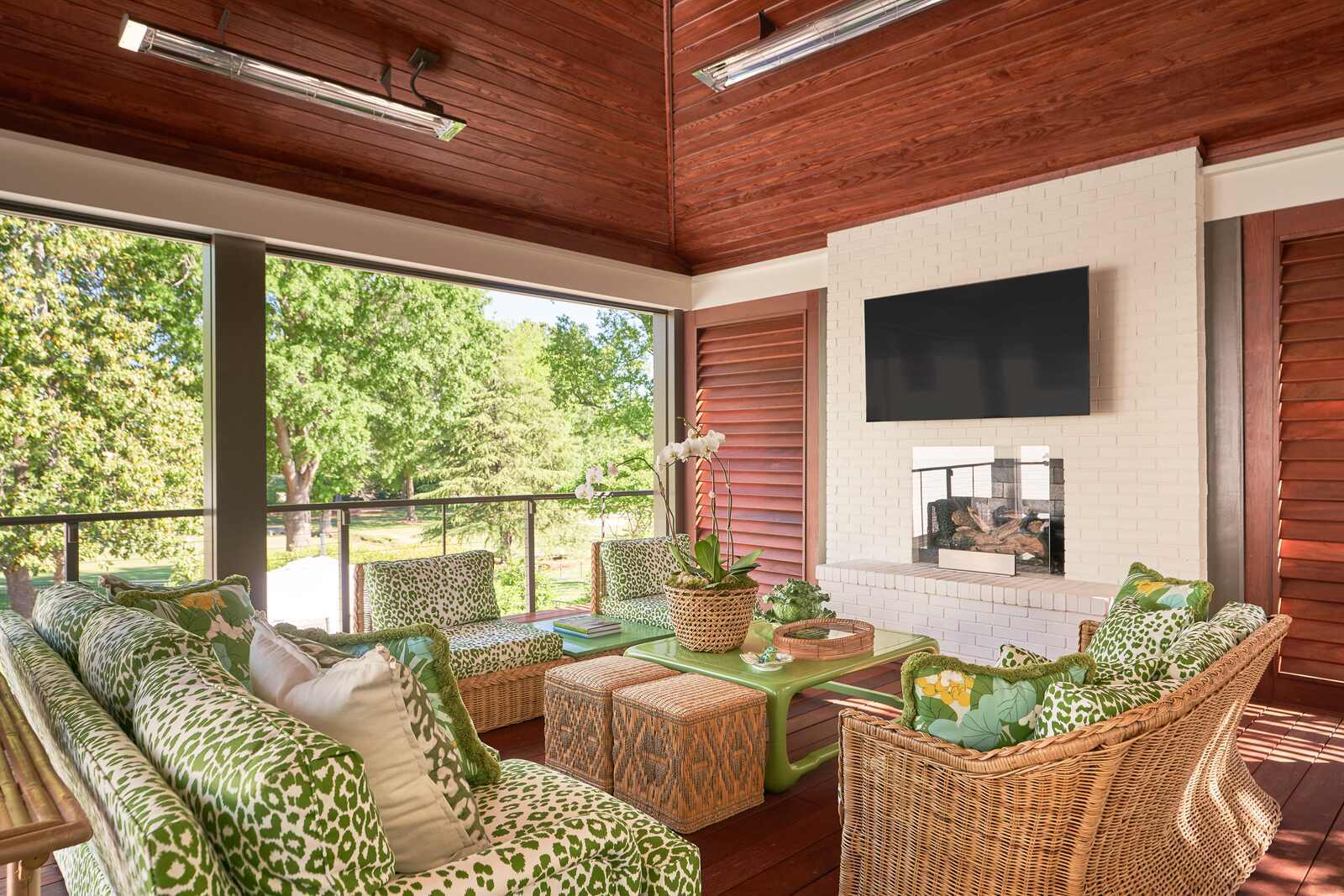 Stylish outdoor lounge area with cozy seating and wall-mounted TV