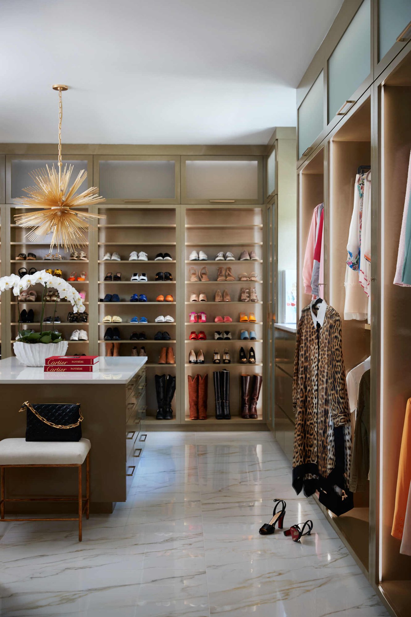 Luxurious walk-in closet with organized shelves and shoe display in Greensboro NC by Wolfe Homes