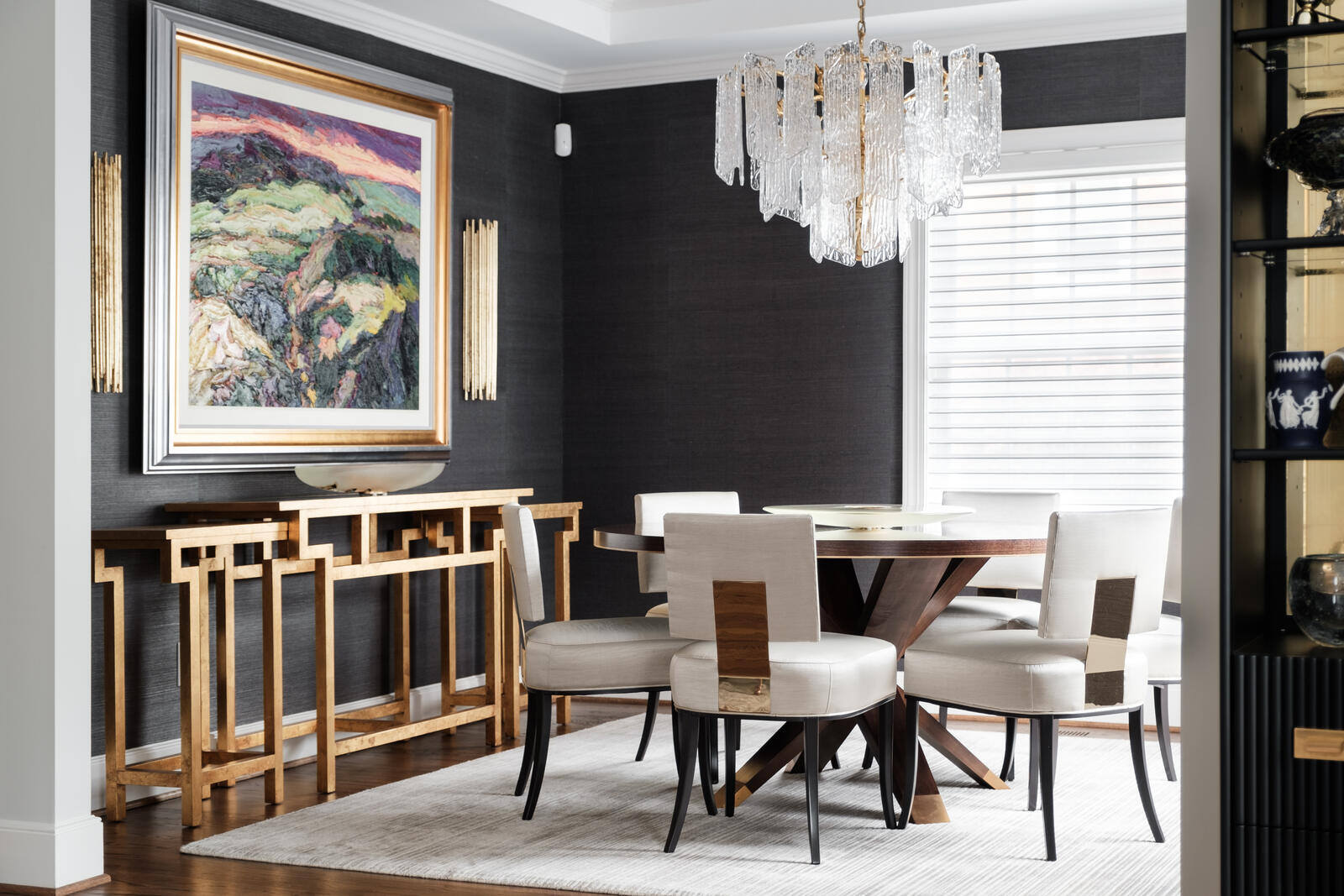 Custom dining room remodel with modern chandelier and wall art by Wolfe Homes in Greensboro, NC