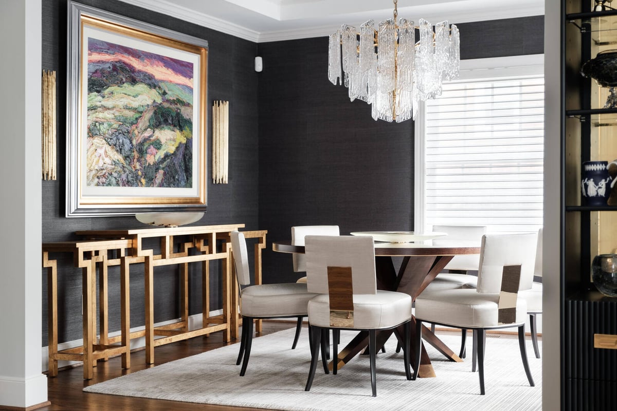 Custom dining room remodel with modern chandelier and wall art by Wolfe Homes in Greensboro, NC
