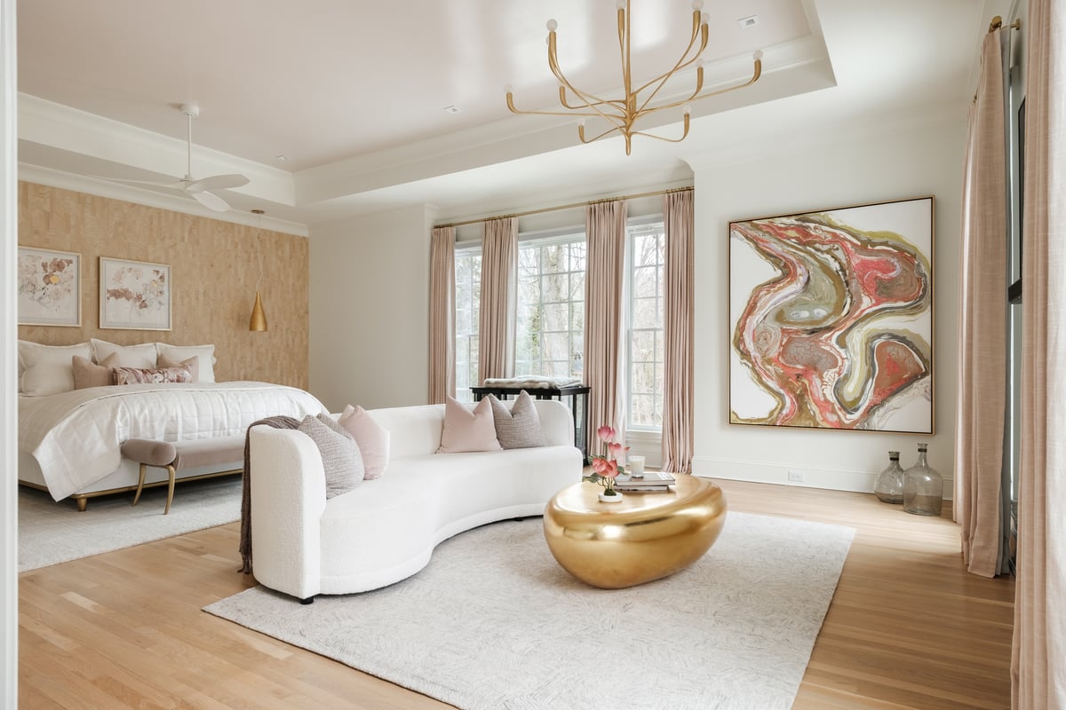 Primary bedroom suite with hardwood flooring and tray ceiling