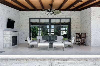 Covered outdoor seating area with fireplace in a Wolfe Homes custom home in Greensboro, NC
