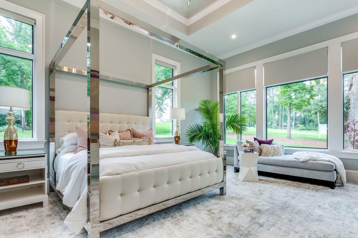 Greensboro custom bedroom with large windows and modern four-poster bed by Wolfe Homes
