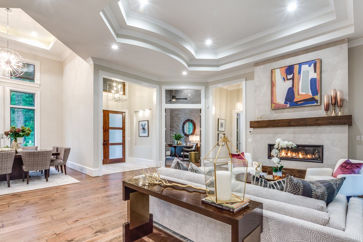 Open-concept living room in Greensboro custom home by Wolfe Homes, featuring a modern fireplace and stylish decor