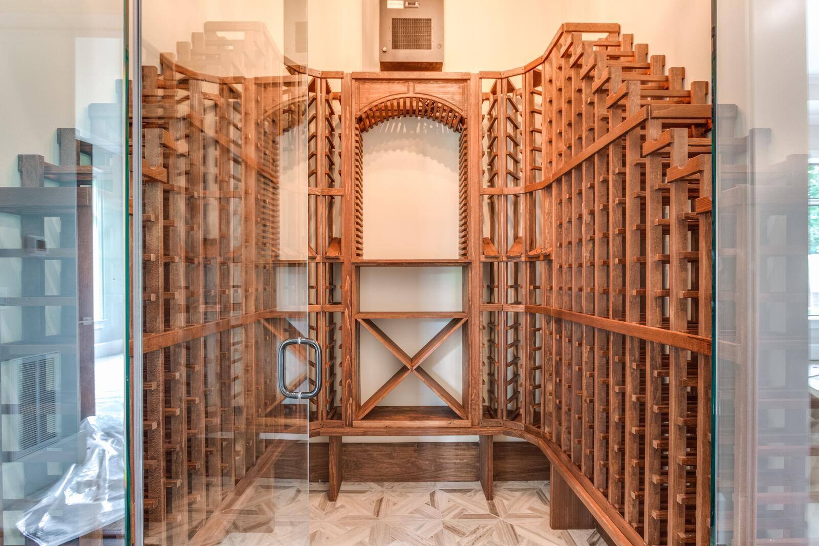 Custom-built wooden wine cellar with intricate shelving design by Wolfe Homes in Greensboro, NC