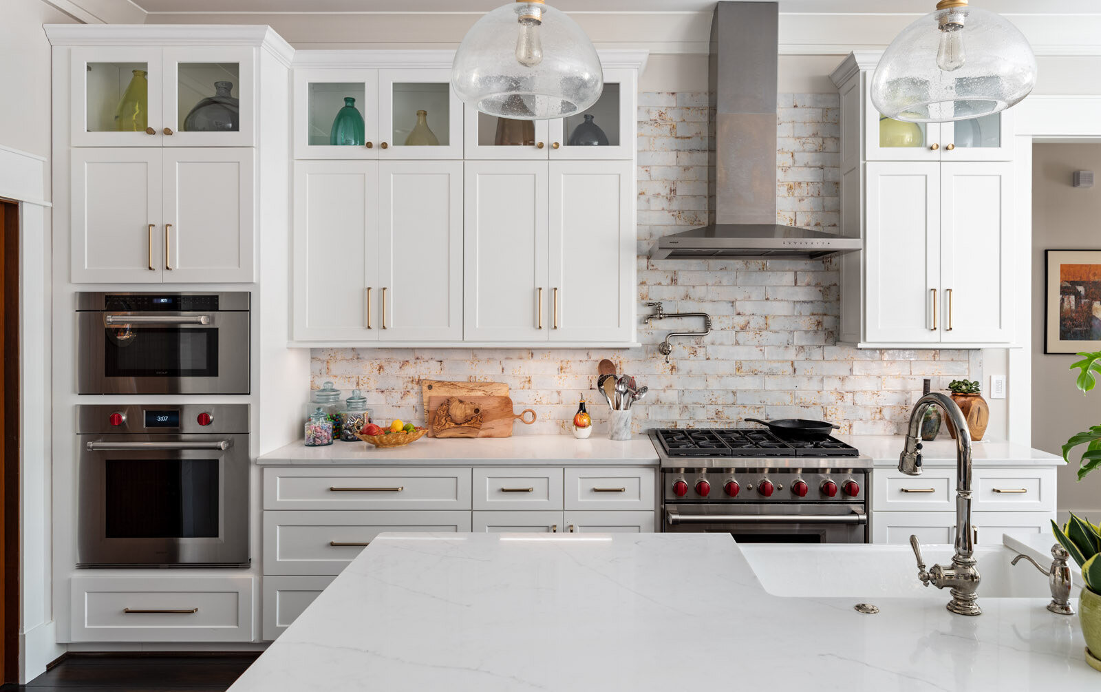 Elegant kitchen remodel by Wolfe Homes in Greensboro, NC, featuring a stylish oven setup and ample storage