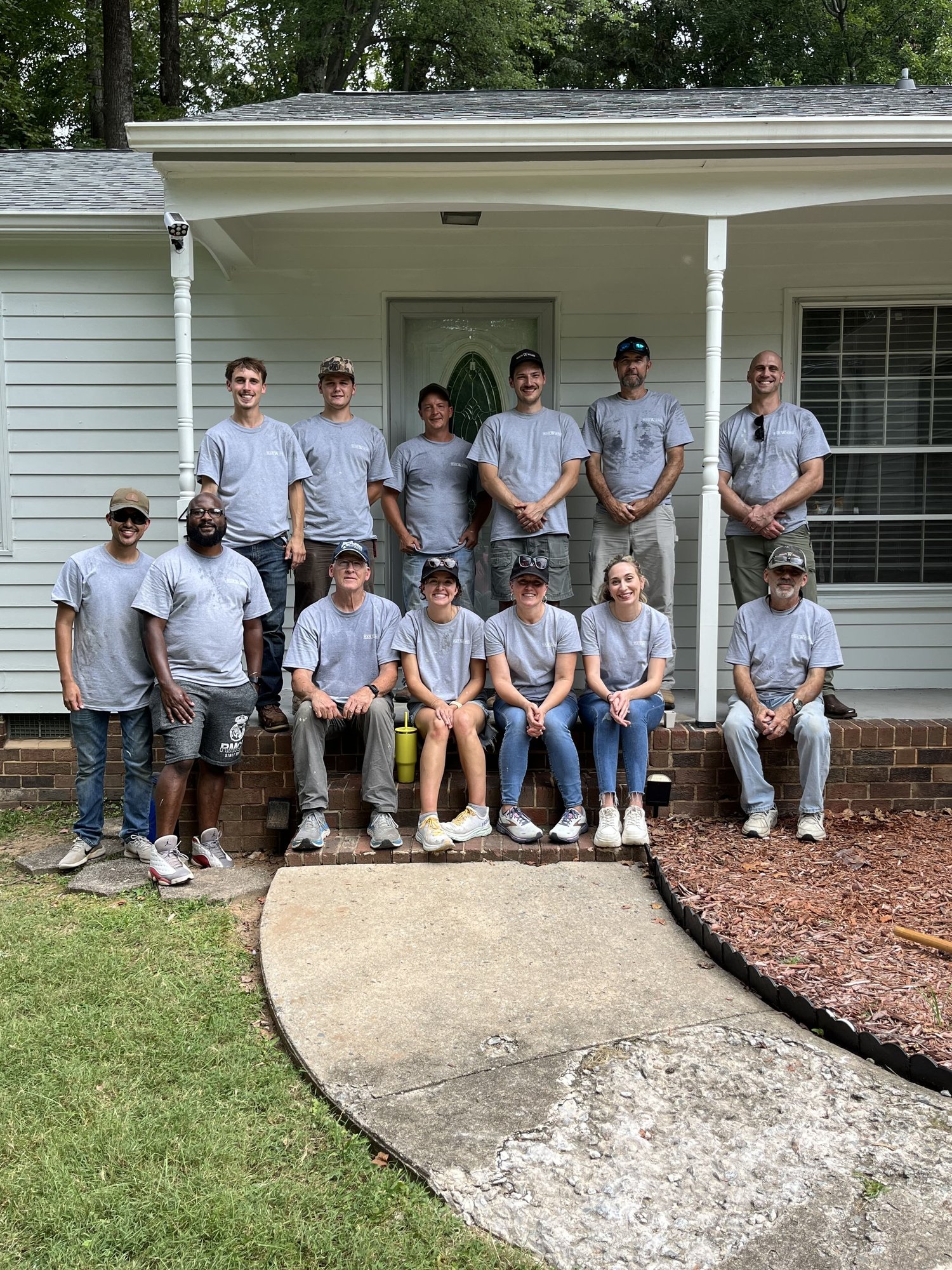 Wolfe Serves_team photo on front porch of project property