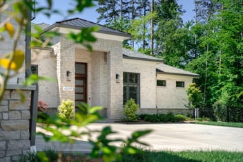 Wolfe Home: white stone exterior, grand entrance, modern design