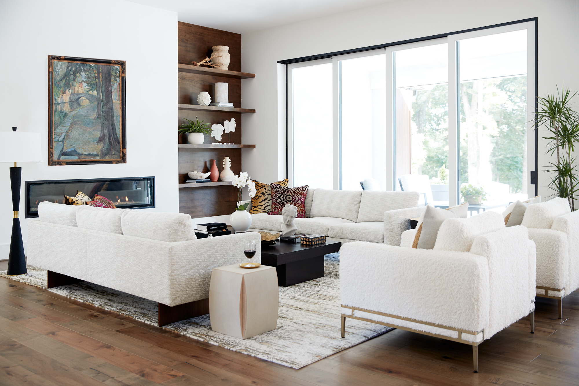 Modern living room with built ins and full length windows in Greensboro, NC by Wolfe Homes