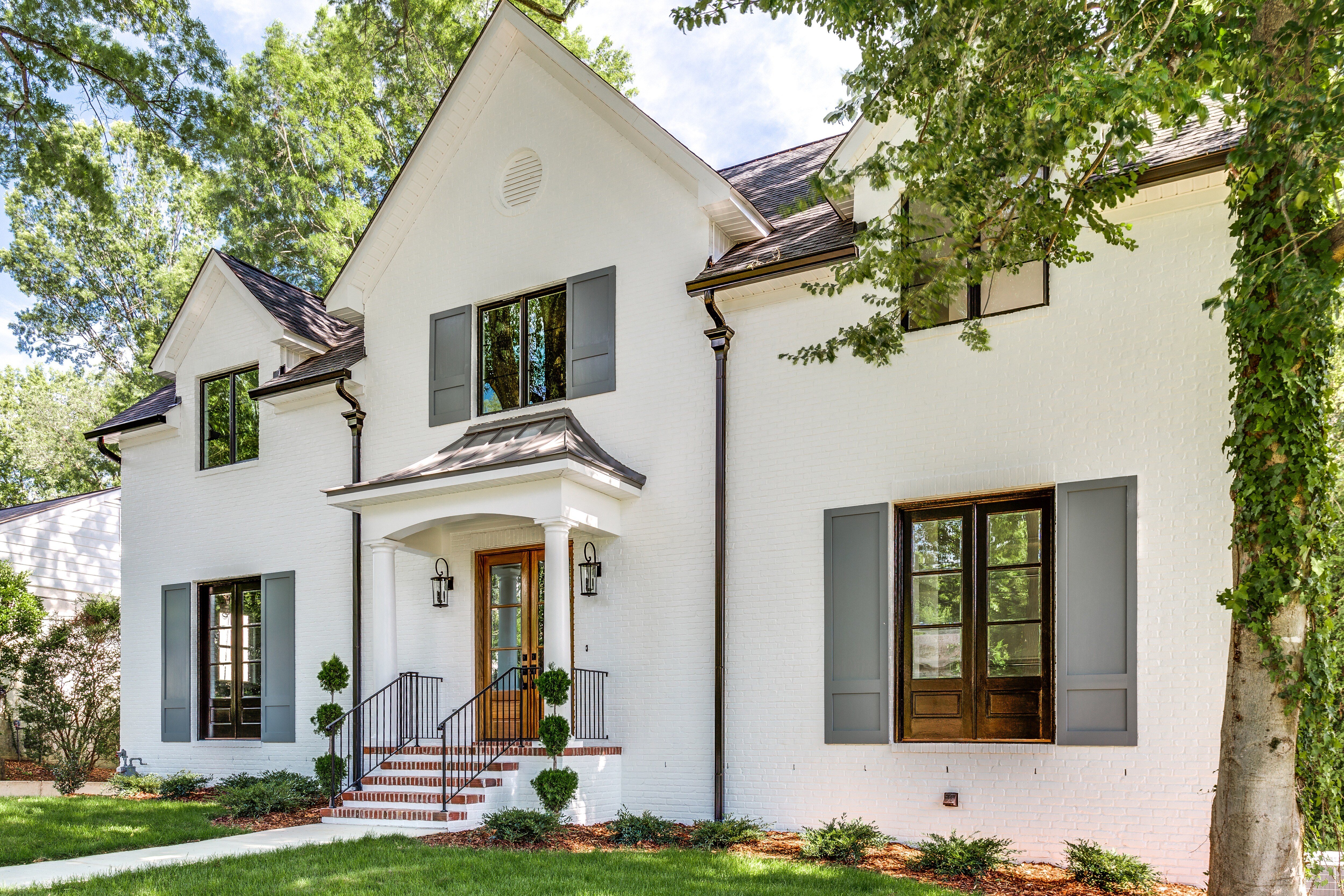 Renovated Modern Farmhouse with white brick and copper accents by Wolfe Homes