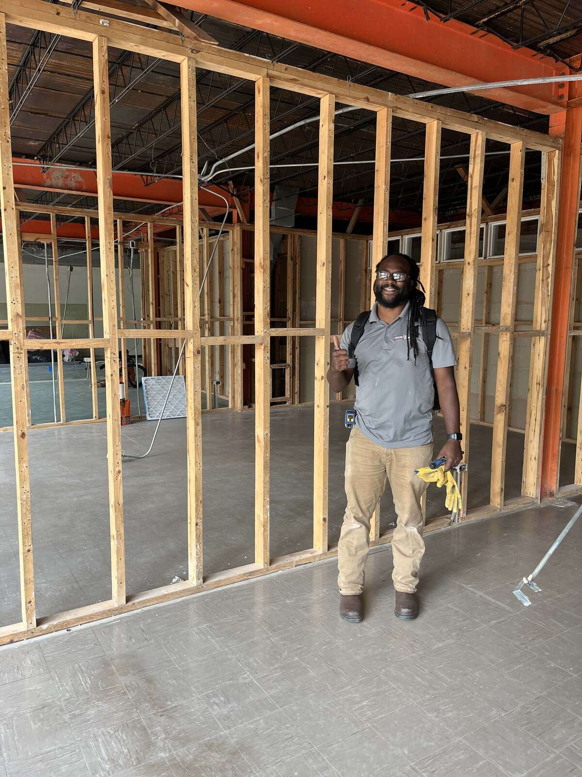 Wolfe Homes staff member posing inside a construction site in Greensboro, NC, highlighting home building careers