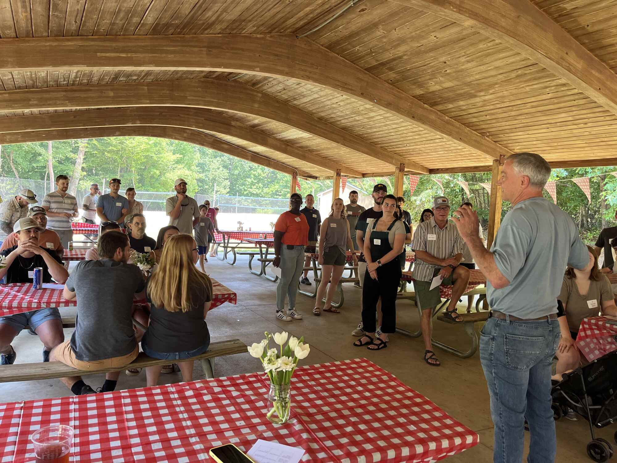 Wolfe Homes team event under a wooden pavilion in Greensboro, NC, showcasing home building careers