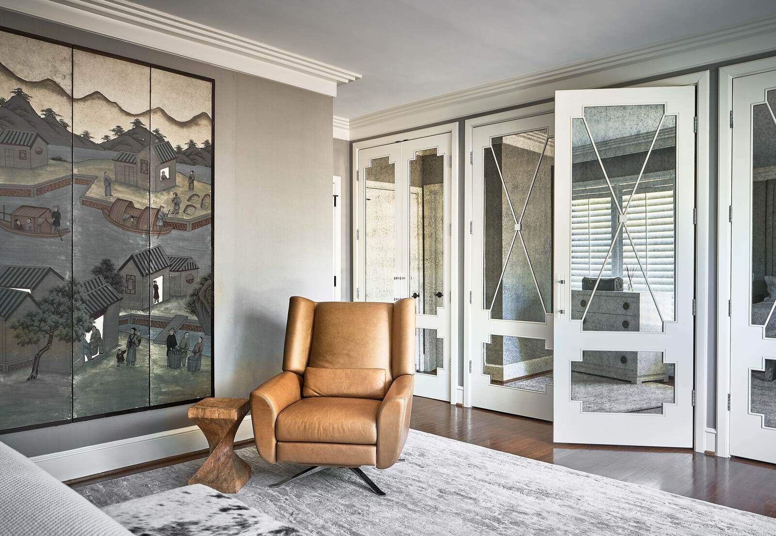 Bedroom with decorative Asian-inspired wall art and mirrored closet doors