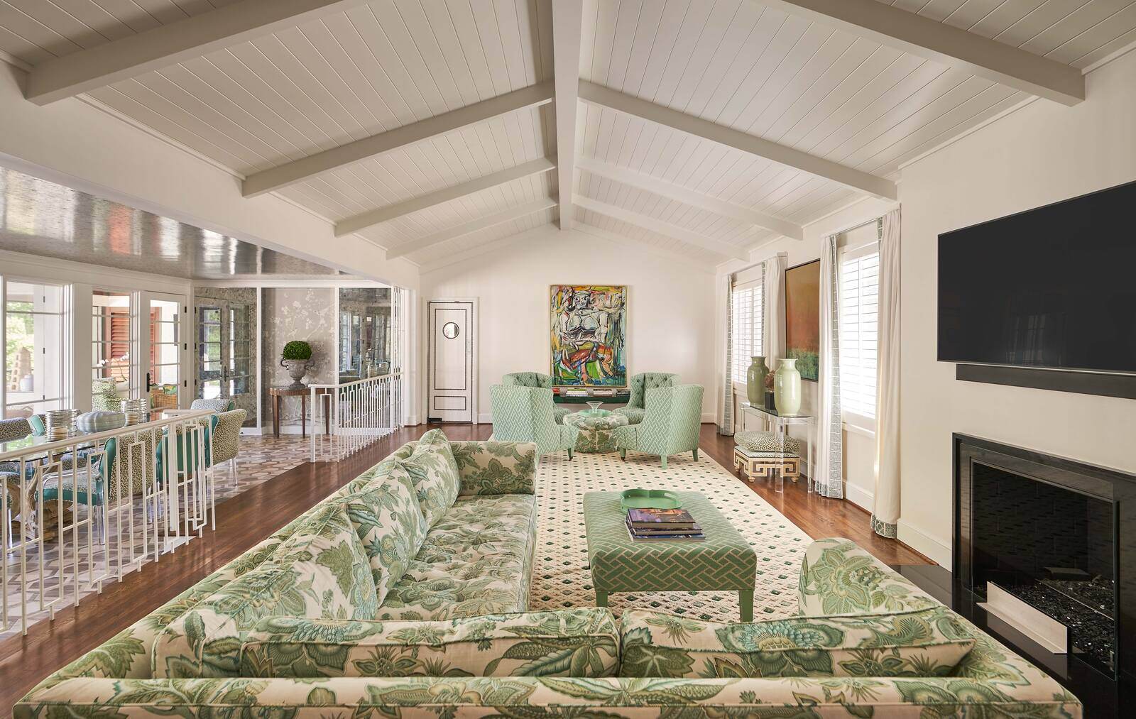 Spacious living room with vaulted ceiling and floral-patterned furniture