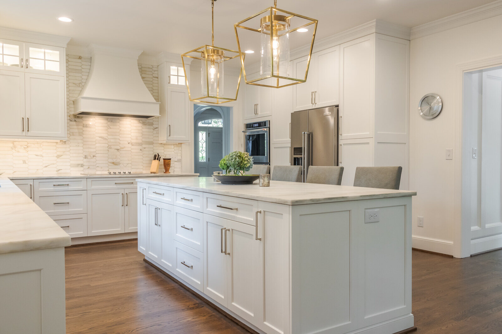 Luxurious white kitchen with pendant lighting remodeled by Wolfe Homes in Greensboro, NC