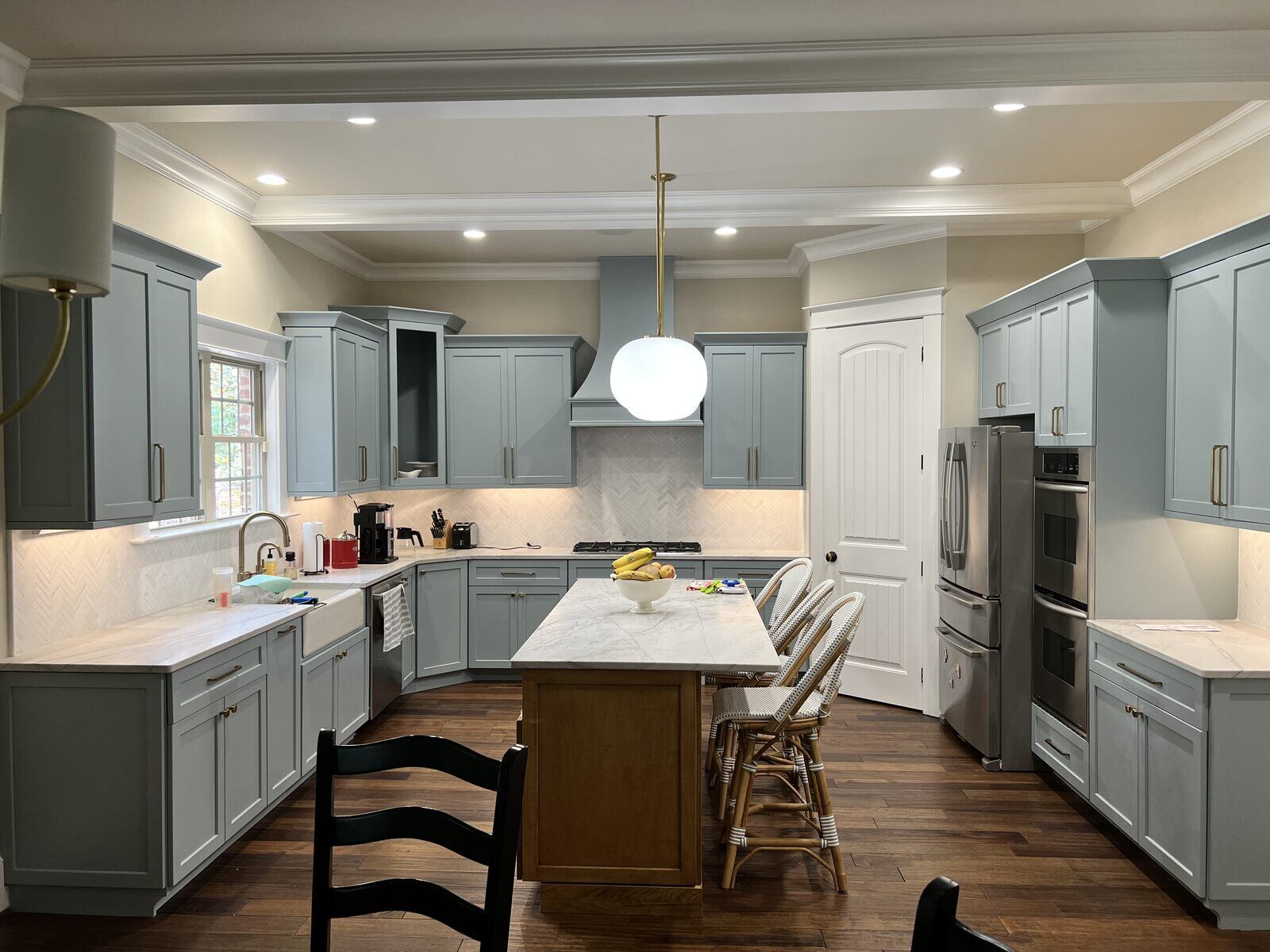 Modern kitchen renovation with blue cabinetry and marble island by Wolfe Homes in Greensboro, NC