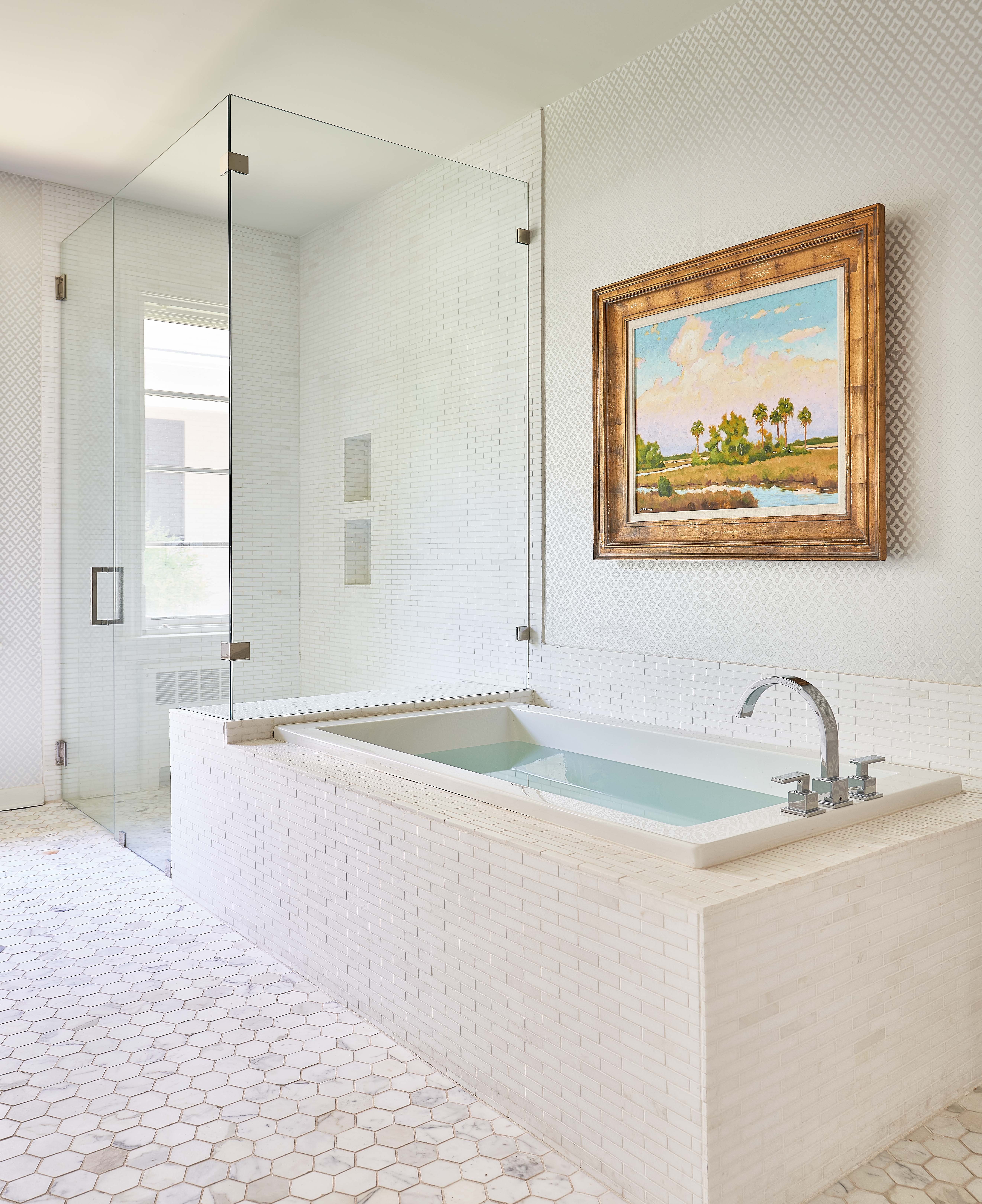 White tile bathroom floor and custom bathtub with glass shower in Greensboro, NC by Wolfe Homes